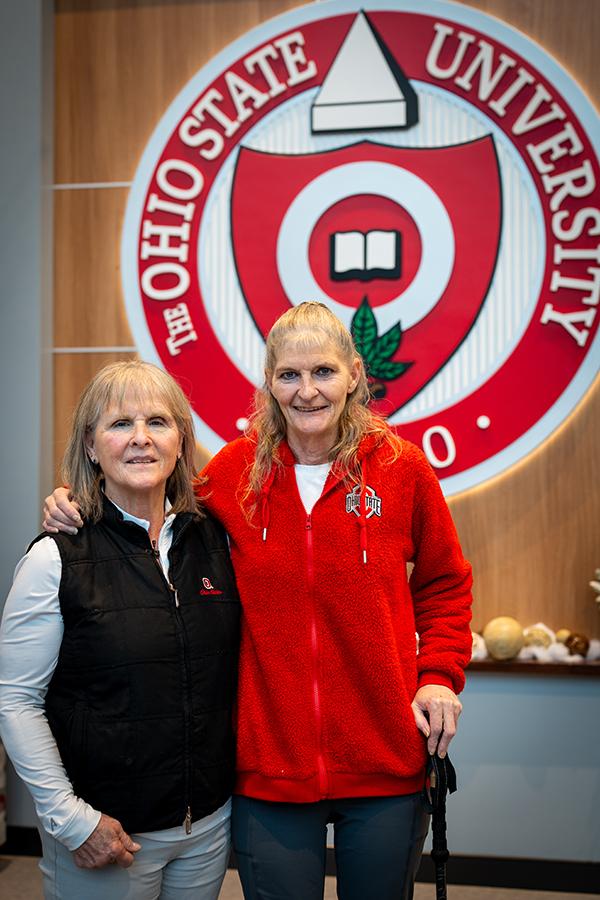 Ilene and Joann posing together in front of the university seal.